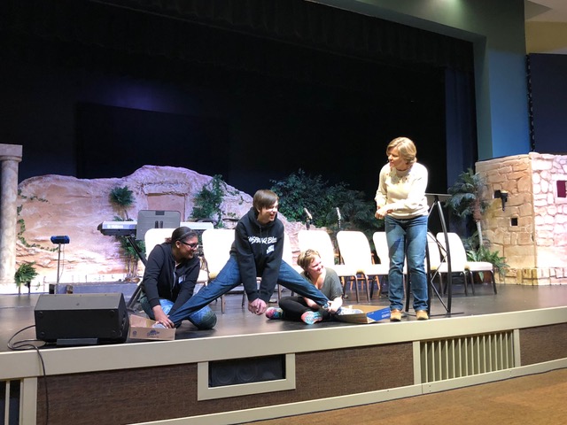 Kate Wylie and three good-natured volunteers illustrate how difficult it is to have one foot in the world and one foot in the Kingdom.