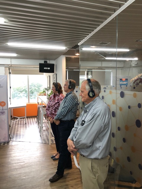 . . . and Paul, Doug, and Julie listen through simultaneous translation headphones.
