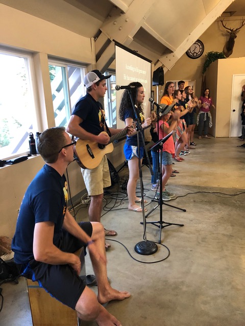 Robert and Jacob Kovacs and Whitney (Jacob’s fiancée) teach the memory verse song at family camp.