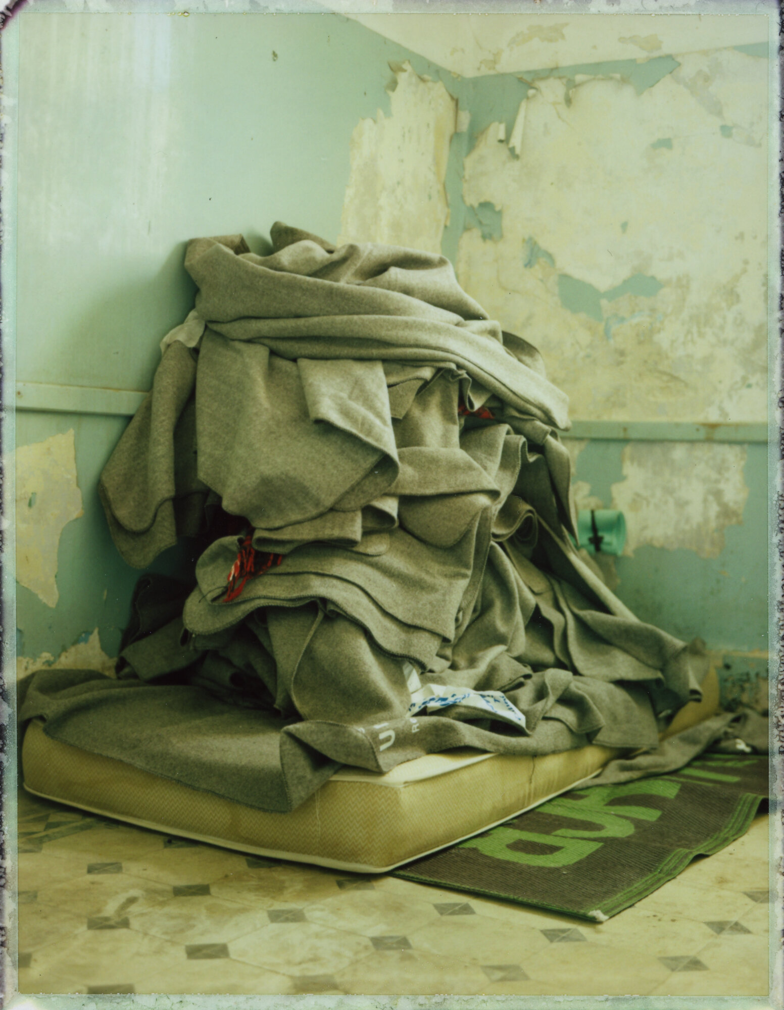  Blankets provided by the United Nations High Commissioner on Refugees pile up in an abandoned building on the island of Leros as refugees shed bulk in preparation for advancing farther into Europe.&nbsp; 