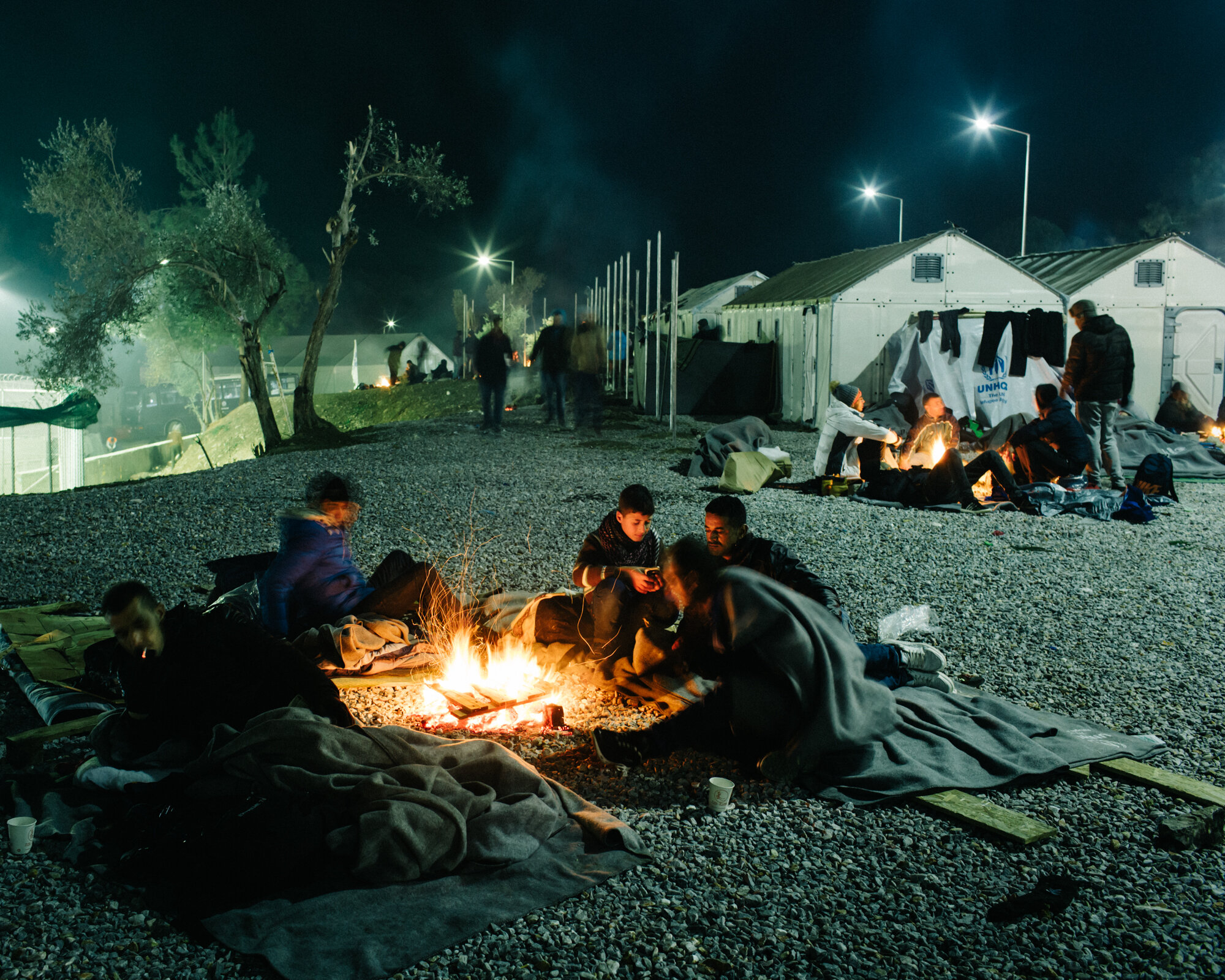  Through the freezing rain, refugees wait through the night where they can, harboring fires for warmth. 
