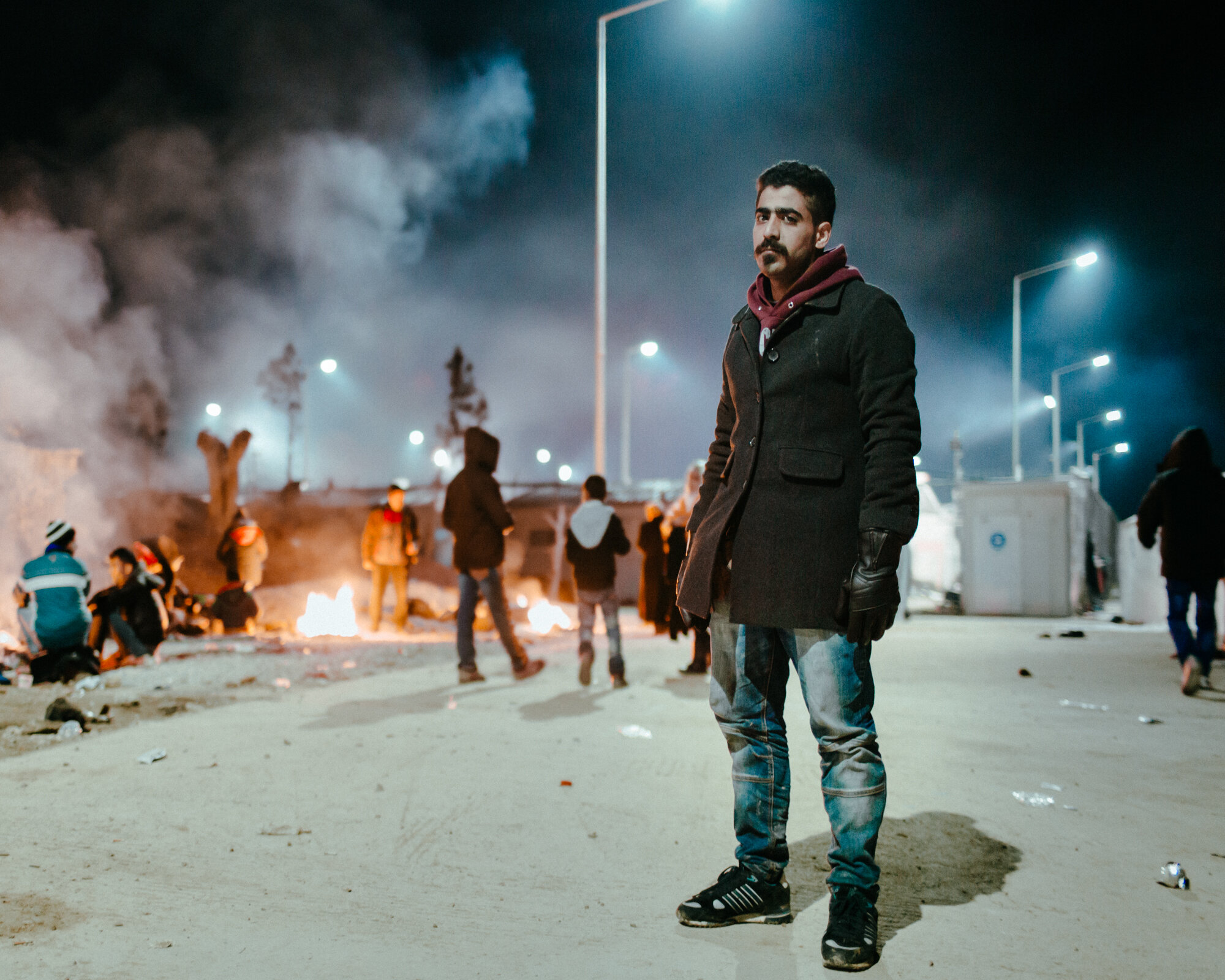  Abu Hasan who fled war in Syria, stands for a portrait as the night consumes Moria.  