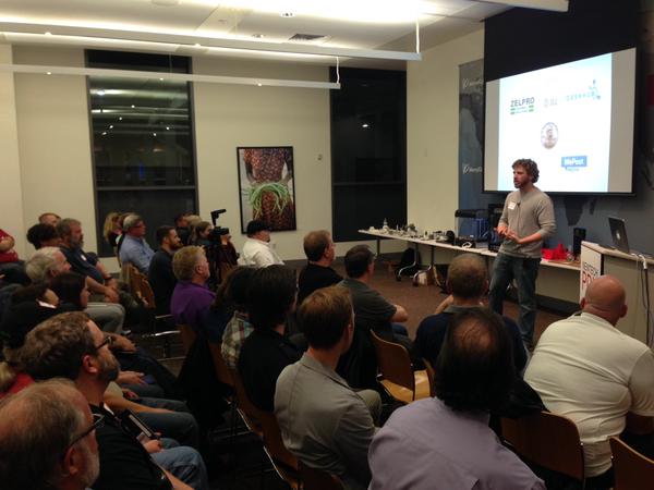 Kris Beem, Business Development at RapidMade explains 3D printing to audience at NewTech PDX event.