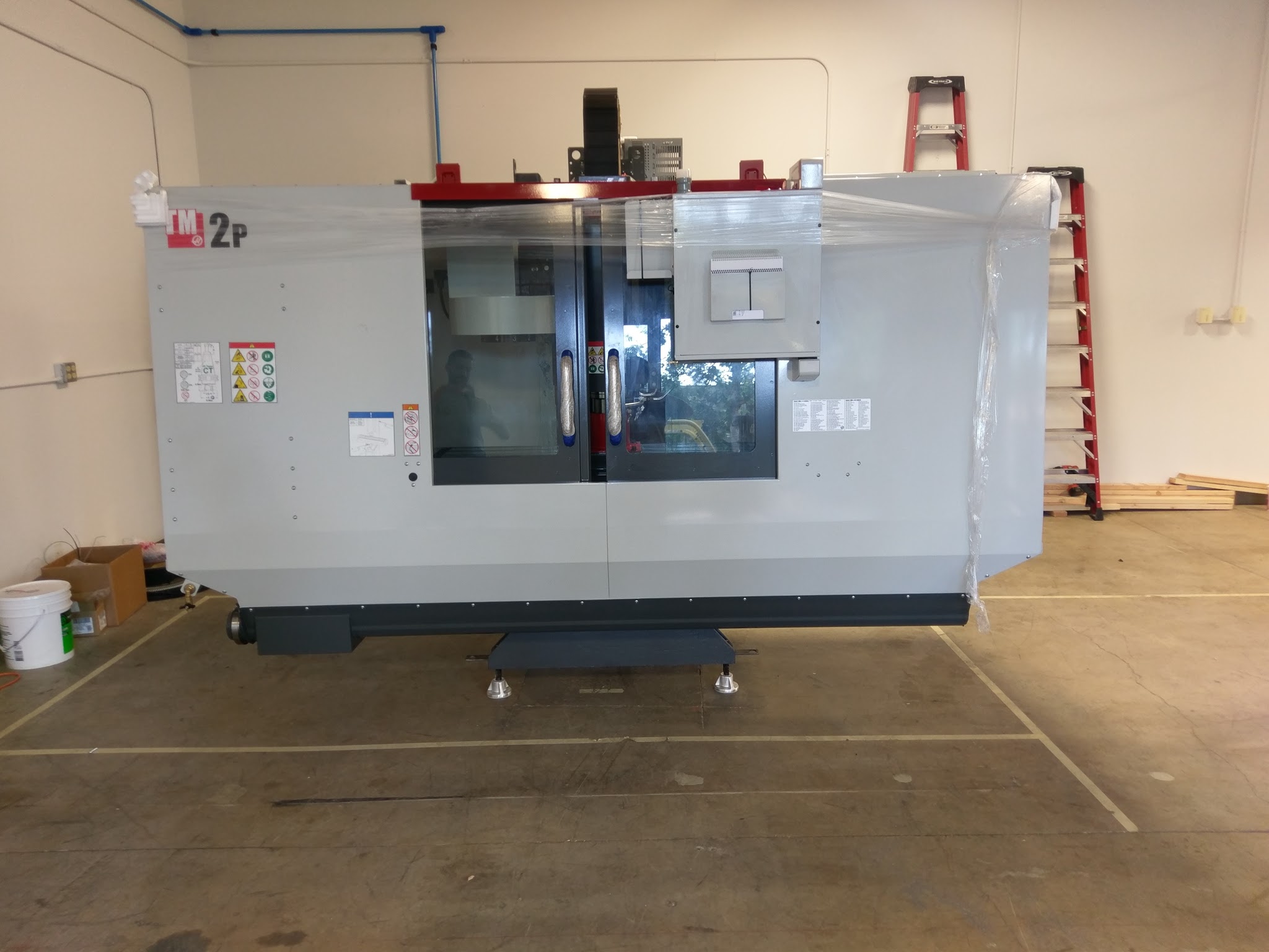 Our new HAAS CNC machine is "sitting pretty" in our new location.