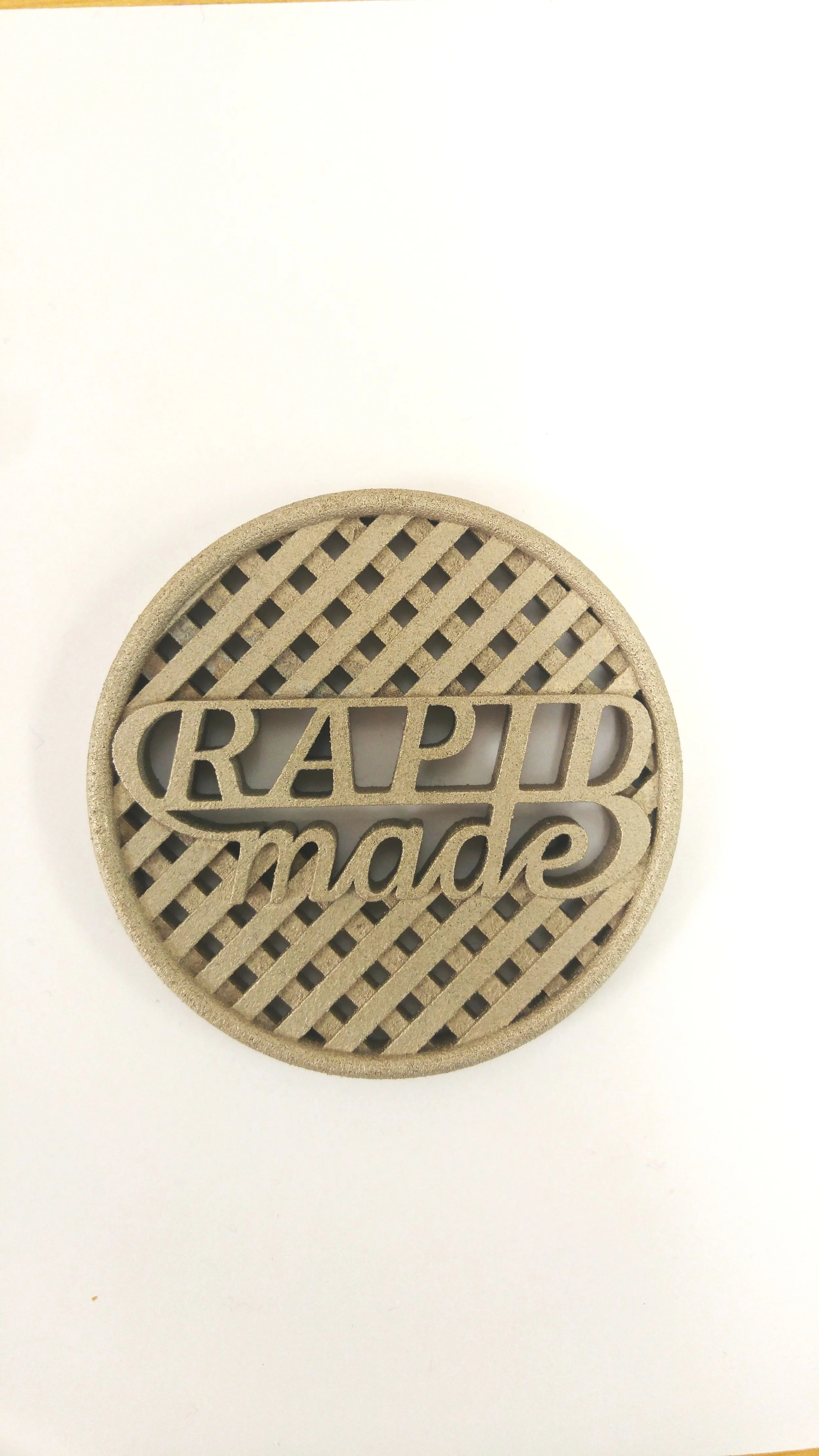 SLS 3D printed metallic logo made with aluminum-filled nylon.