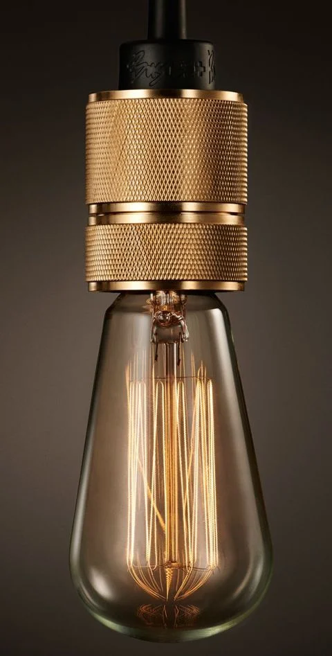 Modern brass lighting and take off on vintage version but not usually seen in brass. ( Elle Decor )