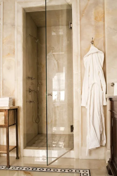 A master ensuite featuring custom designed onyx floor and walls and vintage brass cabinet for towels. (Casey Design/Planning Group Inc. - Photo by Ted Yarwood)