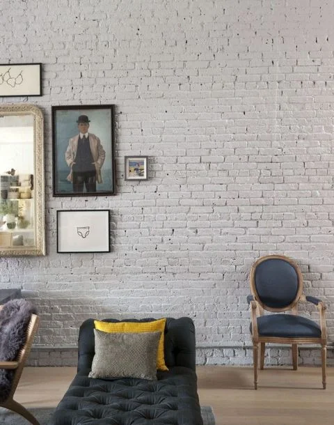 The brick walls have been painted and there is a hint of whimsy to the wide-open space that makes it very appealing. ( Remodelista )