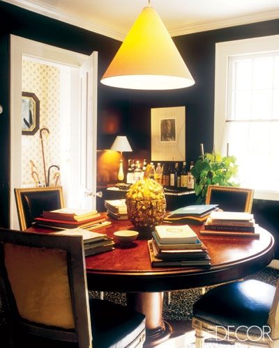 Love this cozy library/dining room featuring black walls ( Elle Decor ).
