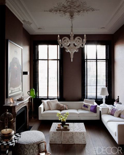 Living room: love the black walls, contrasted with the wife sofas and fantastic, patterned coffee table ( Elle Decor ).