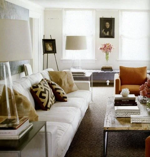 Love the textured, diamond-patterned brown floor with the graphic pillows surrounded by the white backdrop. Simply sophisticated! ( DPages ).