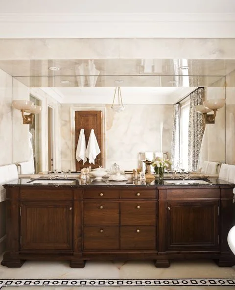 The walnut, double vanity in combination with the creamy, white onyx floors and walls creates a glamorous soft and soothing ensuite retreat (Casey Design/Planning Group Inc. - Photo by Ted Yarwood).
