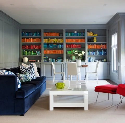 What is more bold than a velvet indigo sofa? We love how playful this room is with the bright penguin books and accessories. (Casey Design/Planning Group Inc. - Photos by Ted Yarwood).