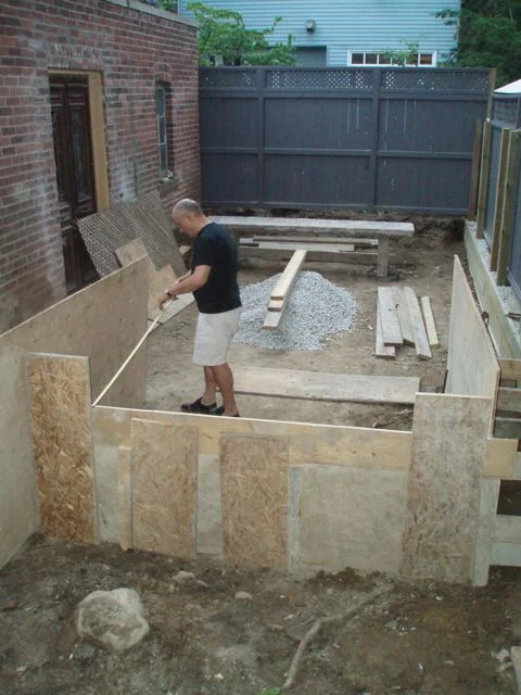 Theresa's husband, Robert, mapping out the lower courtyard, following the plan's outline of the upper terrace/dinning area.