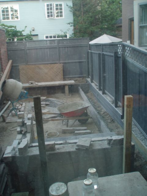 The garden, stripped down to its bare elements - including the single slab stone bench at the back - before weathered stone was laid for the floor and steps up to the terrace.