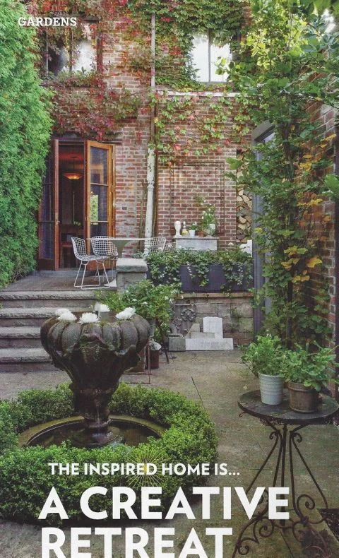 The garden in full growth after the reconstruction - seen from the back - with the salvaged fountain centered in the lower courtyard.