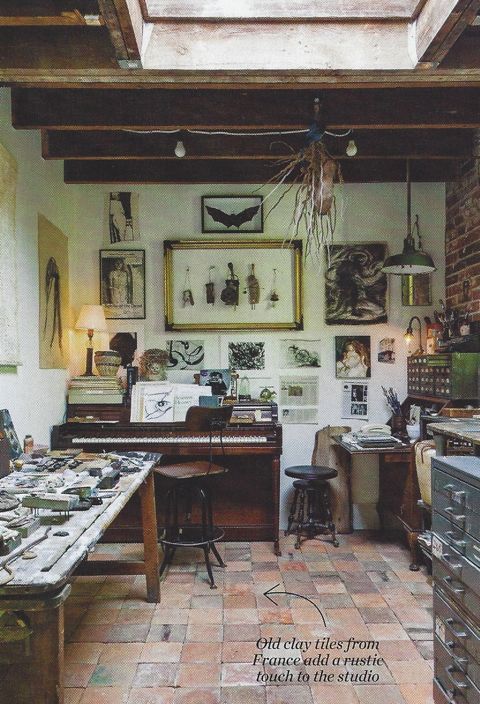 Once a garage used for storage, the studio features exposed brick, salvaged antique French clay tiles and wood beams that create a sense of age and character. 