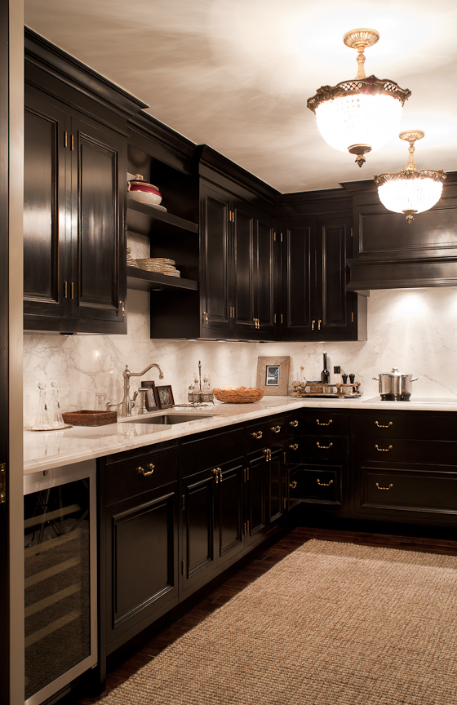A Calcatta marble slab acts as the countertop and backsplash. This marble creates a uniform look that intrigues with its stark contrast to the dark cabinetry. (Casey Design / Planning Group Inc. - photograph by Ted Yarwood)