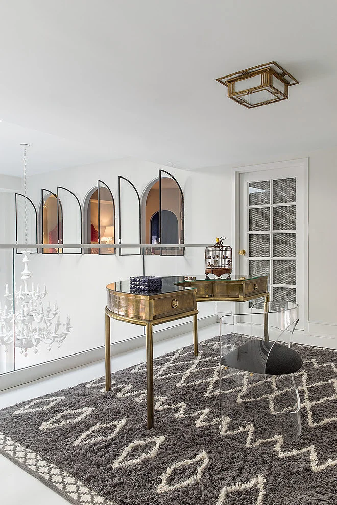 This bold brass desk, stark white walls and textured graphic-patterned rug work so well together because of their inherent differences. Dissonance can be a strong tool for successful rooms. ( James Dixon Architects - photograph by Michael Stavaridis)