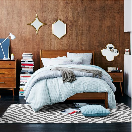 This simple wood stained bed frame in the med-century modern bedroom by West Elm is full of texture, pattern and colour. What a relaxing and intriguing haven to come home to after a long day! ( West Elm )