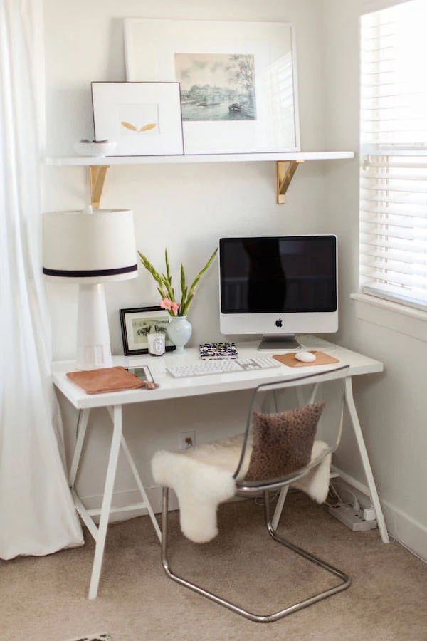 This small home office is an efficient use of space in a master suite. Keeping furniture and accessories neutral allows the office to be tucked away from view when needed ( Harper's Bazaar )
