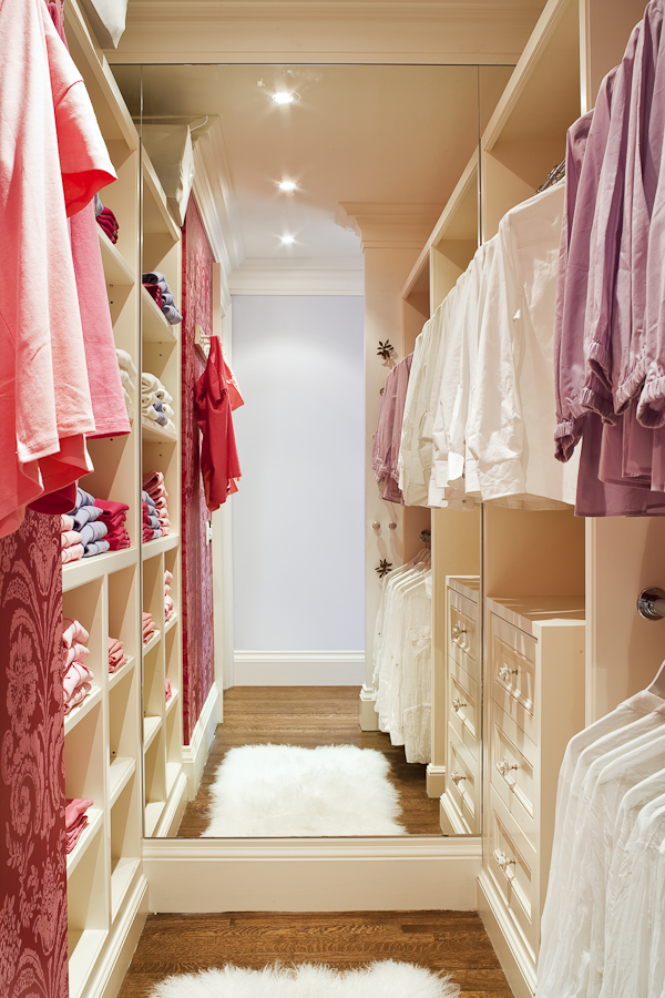 A floor to ceiling mirror is very useful in a walk-in closet. It also makes the space feel larger and more open. Bright task lighting allows our client to effectively use her closet space. (Casey Design / Planning Group Inc.- photograph by Ted Yarwood)