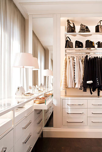 Open clothing racks above drawers makes this closet feel like a retail space. It allows key pieces to be displayed, while still allowing for plenty of storage and organization. ( West Coast Capri )