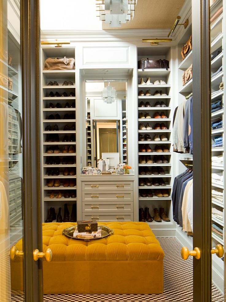 Open shelving in all areas of the closet allows for easy access to a wardrobe. Yellow details such as the ottoman and hardware create a sense of playfulness and character in the space. ( Nate Berkus Designs)