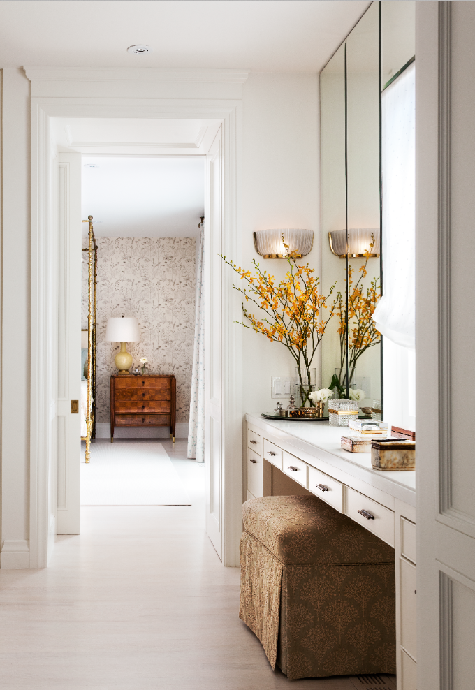 The bamboo inspired brass bedposts, unlacquered brass handles and small brass accessories tie the look together, and add a level of luxury to this white master bedroom for a young couple. (Casey Design/Planning Group Inc. - photograph by Donna Griffiths)