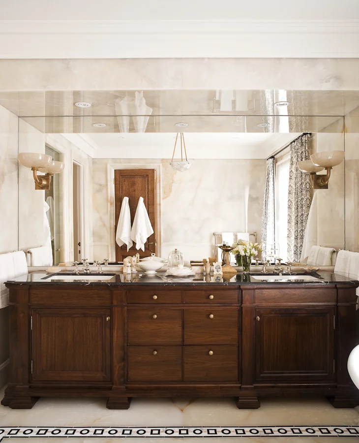 The faucets complement the custom walnut vanity and the 1920's&nbsp;glass sconces.&nbsp;(Photography by Ted Yarwood)