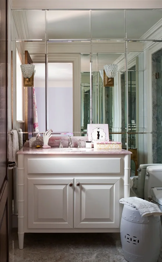In keeping with my philosophy of matching the design to the person, this Ensuite design for my client's daughter was developed to appeal to her "girly" personality and her interest in fashion. The pretty pink marble top with the clean, white vanity is surrounded by floor to ceiling mirrors that hide storage for her make-up and accessories. Any girl no matter what age would love this!