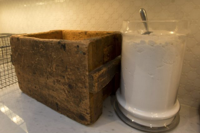 A collection of wooden boxes and old apothecary jars hold such evocative reminders of an old laundry as wooden clothespegs and vintage buttons alongside simple white laundry soap in a glass dispensary with a metal scoop, all of which Casey has sourced on her regular flea market jaunts.