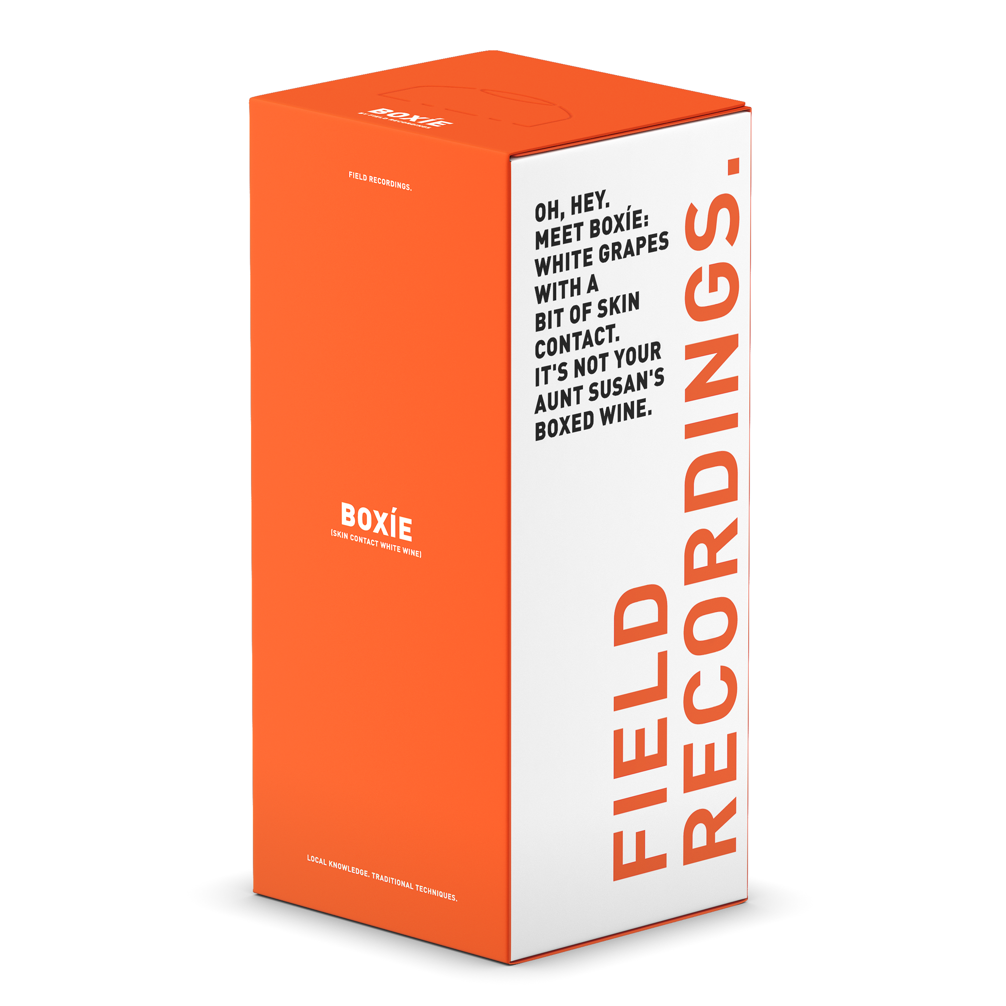 A bright orange and white, tall and rectangular, boxed wine from Field Recordings. The front panel is all orange and reads "Boxie" in white text. The side panel is white with an orange logo and black text playfully describing the skin contact wine.