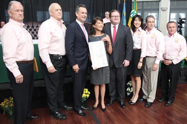 Executive Director, Rachel Piercey (c), with Jefferson Parish Council President, John Young (l) and Board Member, Chris Short (r) surrounded by the Jefferson Parish Council members at the October 7, 2015 Council meeting, following the presentation of the proclamation for National Pro Bono Celebration week. Photo courtesy of the Jefferson Parish Public Information Office.