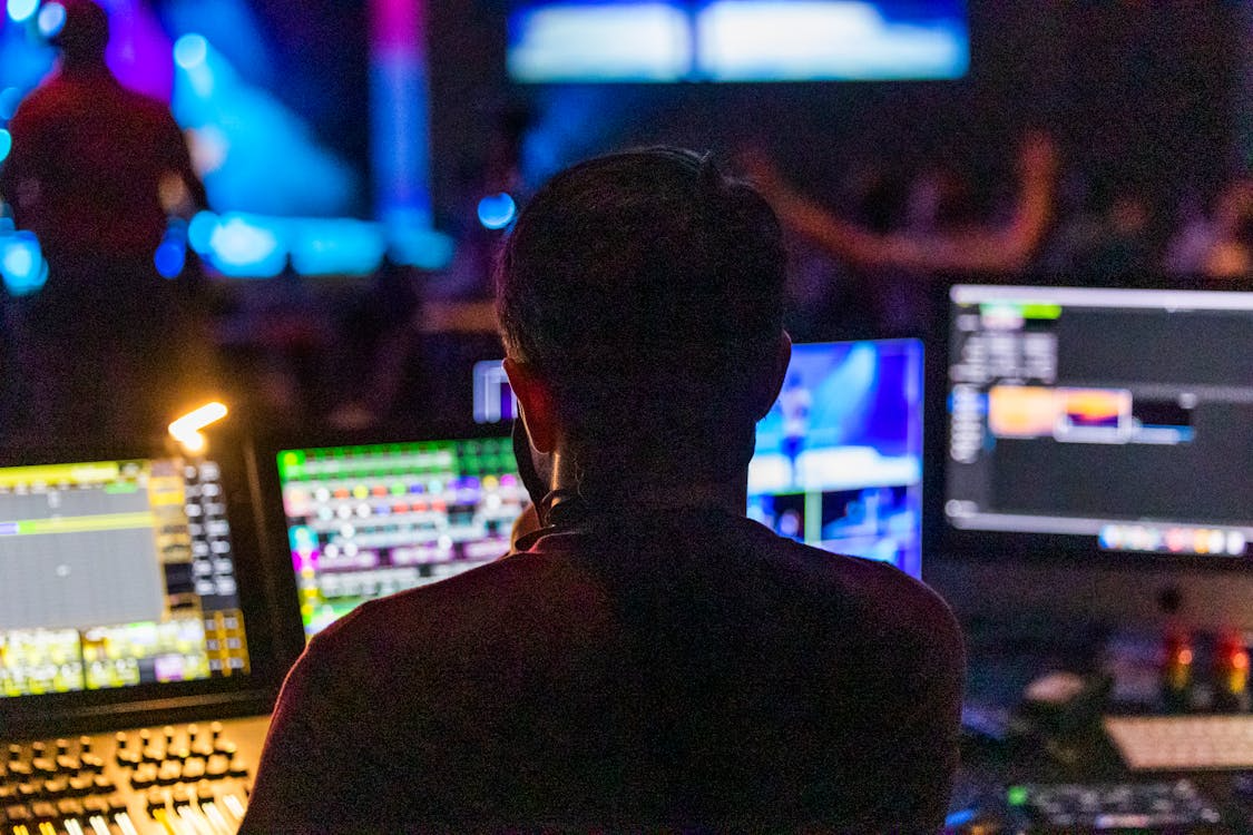 a man in front of computer screens