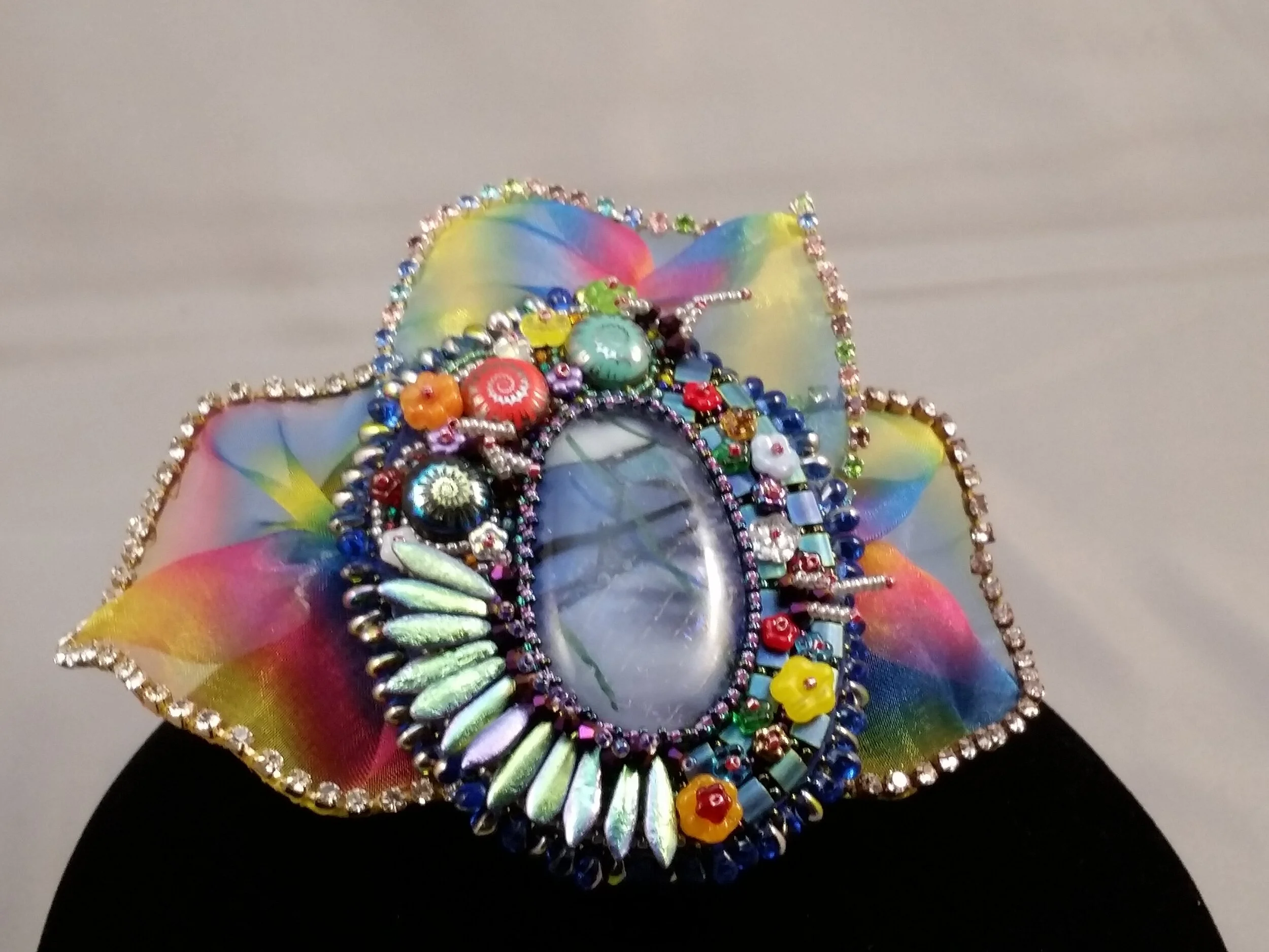 Laborodite bezeled with floweres and tilas.jpg