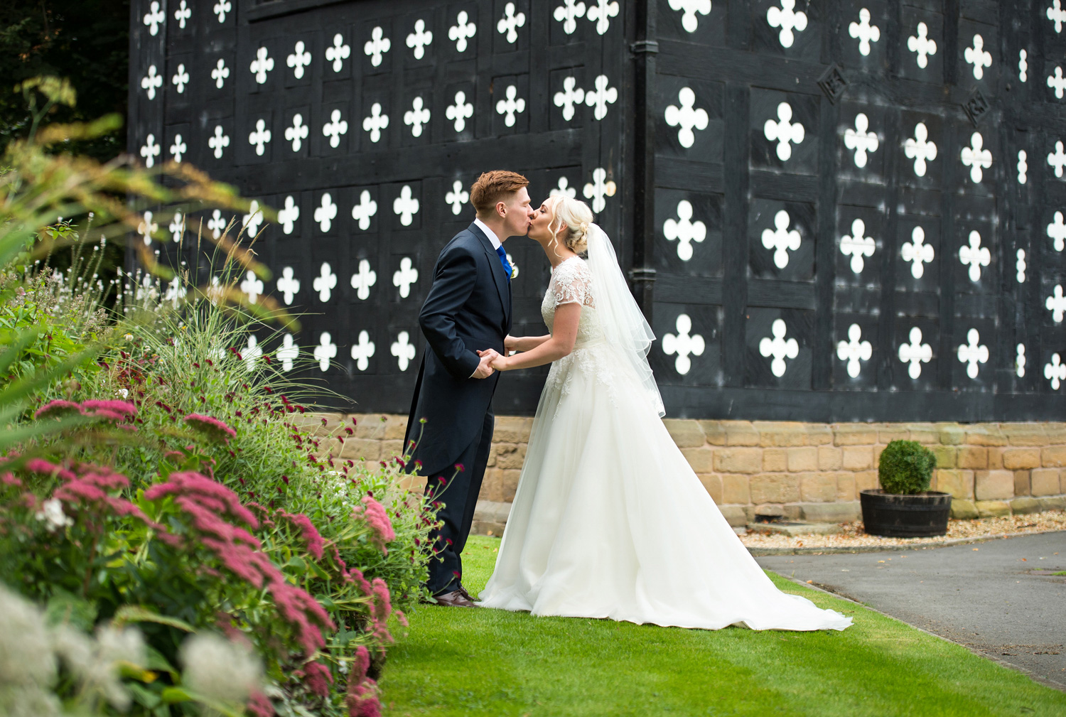 Wedding photograph of a bride and groom outside Samlesbury Hall