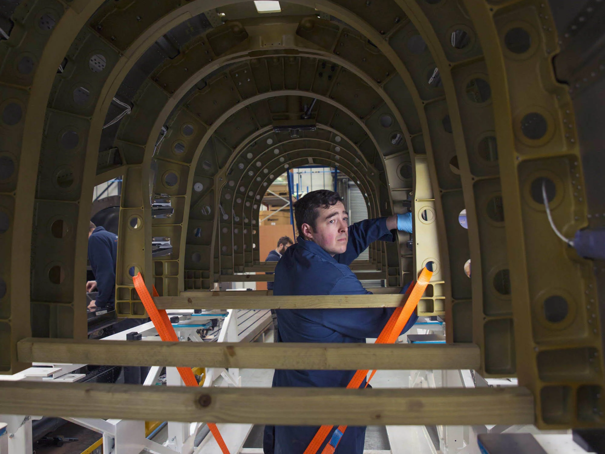 Technician working on the chassis underside 