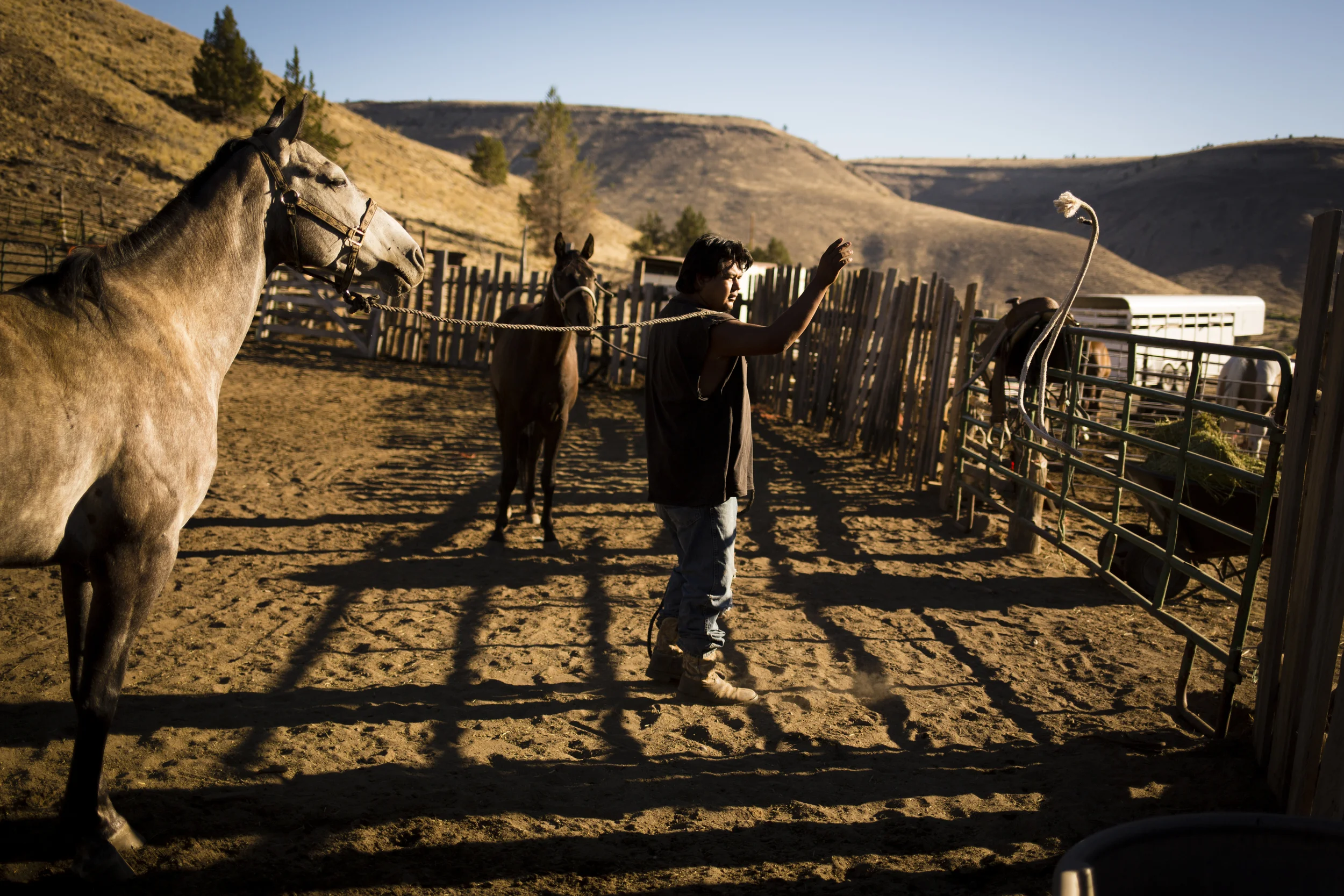 Leslie Rae Robinson tends horses on his grand aunt's property in Warm Springs. Photo by Leah Nash