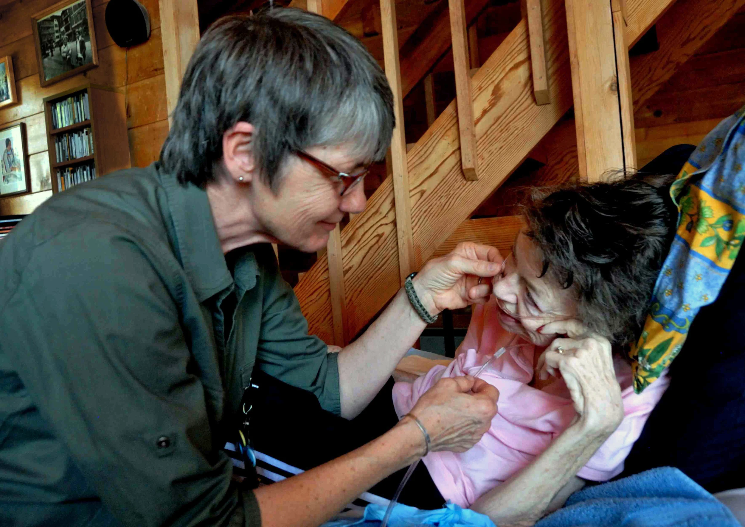 Cindy Andexle, nurse's aide with Willamette Valley Hospice in Salem, assists Elena Lewin. Elena was given two weeks to live in November of 2011. More than 600 days later, she is still with us. Photo by Gerry Lewin