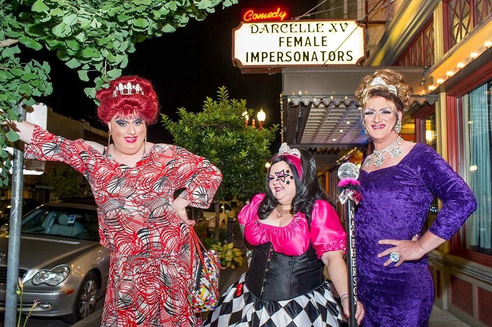 Female impersonators Wayne Chamberlain/Miss Gay Portland, left, and Allen Cole/Miss Gay Oregon, right, join Ms. Gay Oregon/Jennifer Martin, center, outside Darcelle XV Showplace in Portland. Photo by Paul Engstrom