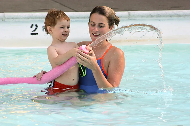 Baxter Desbrow succeeds at spraying water with his swim instructor at the Creston Pool in Portland. Photo by Rebeca Beeman
