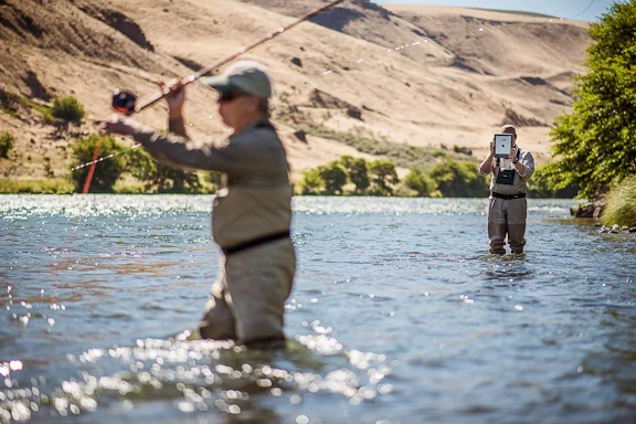 Dan Johnson of Des Moines, WA casts his spey rod while fishing guide, Tom Larimer, records his casting for analysis on an iPad app. Photo by Craig Strong