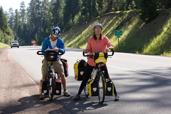 British cyclists Tom Merriman & Jana Phillips take a break at Ochoco Summit - Mile Post 50 on US Hwy 26 - between Mitchell & Prineville. They are in their 10th week of a cross country bike tour from NY to CA. Photo by Diane Kulpinski