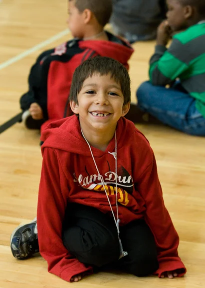 A young student wears a big grin while waiting for his class to begin at the Dual Language Academy, a program taught in both English and Spanish and run concurrently with the district's migrant summer school program at Lincoln Street Elementary. Photo by Michal Thompson