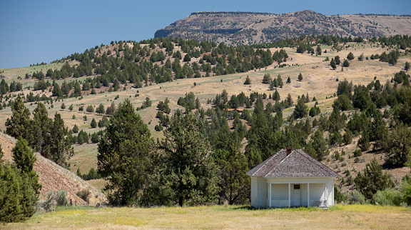 The Waldron School, established in 1874, greets northbound drivers at MP 10 on Hwy 207 between Mitchell & Service Creek. While the school hasn't been used for years, the locals still keep it maintained & welcoming. Photo by Diane Kulpinski