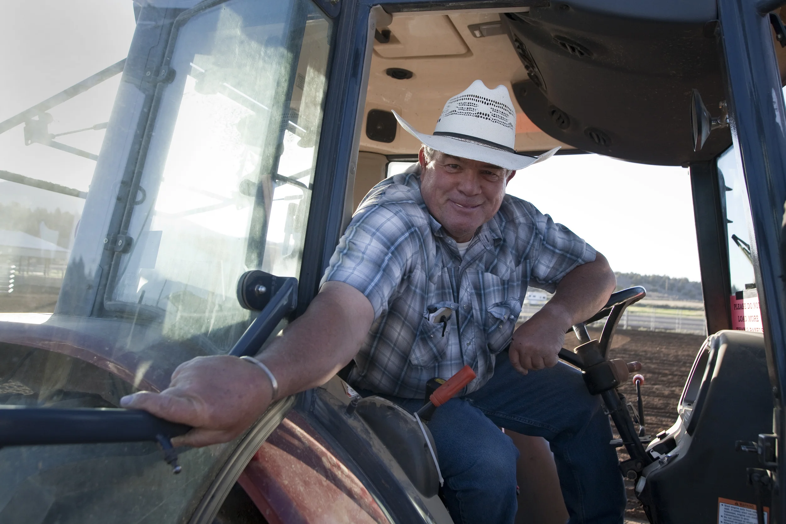Bob Tate of Alfalfa has an easy smile for the camera as he takes a break from prepping the arena for the first day of the Northwest Reining Cow Horse Show hosted by the Rim Rock Riders at their center in Powell Butte.