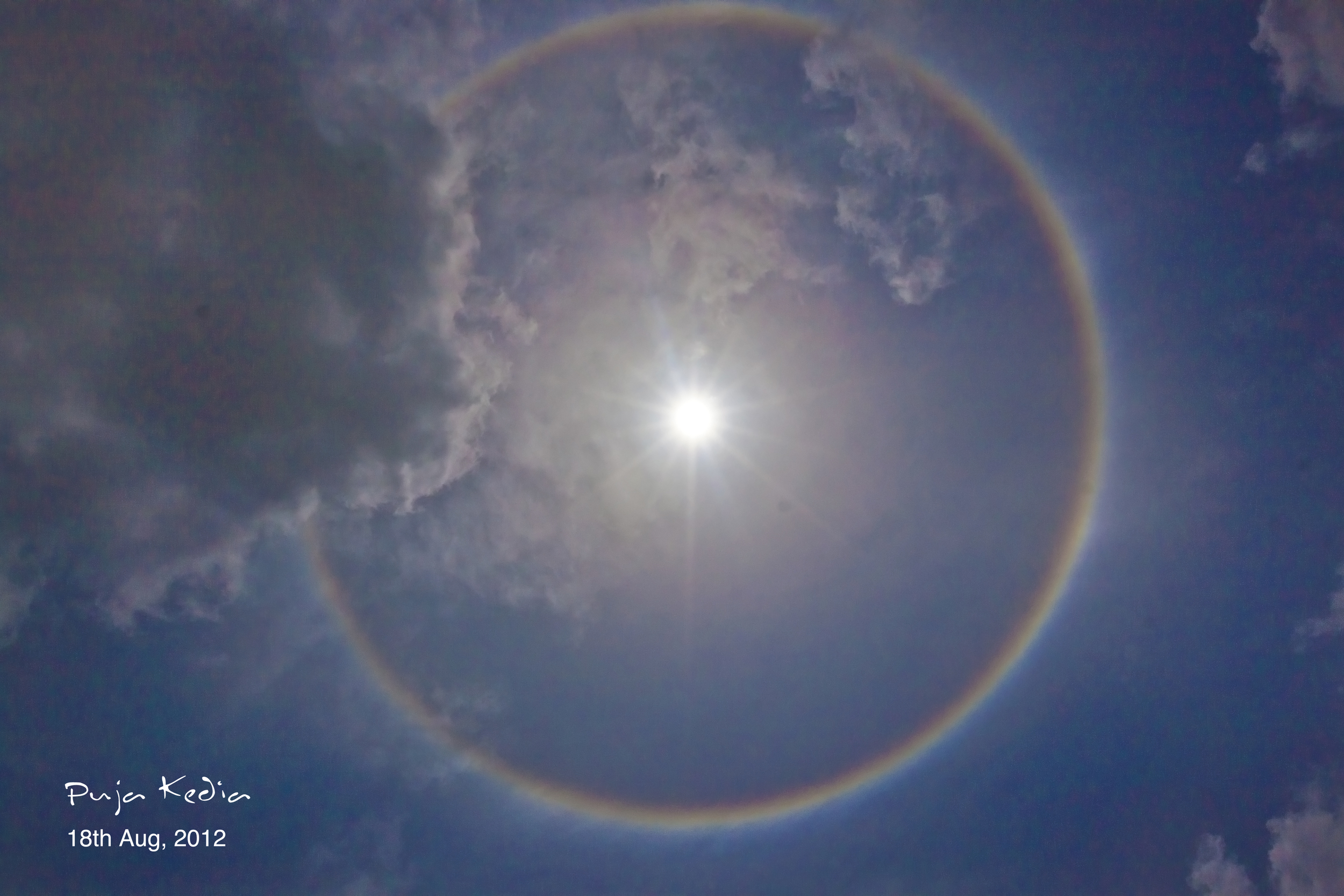 Optica - Image of the Week: Rainbow Ring Optical phenomenon of circular halo  (or 22-degree halo), due to the ice crystals present in the atmosphere.  Observed around 1 pm (IST) from rooftop;
