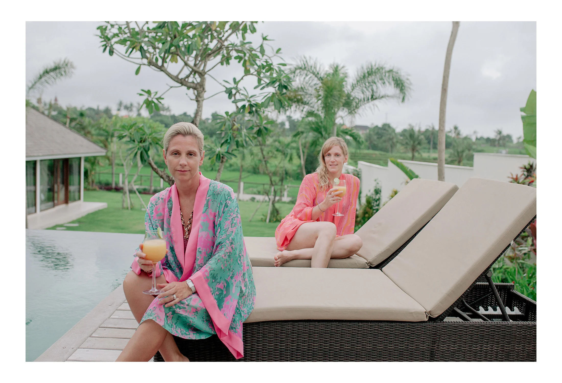Sandra and Esther relax poolside in our Lasata Bloom and Eleuthera Waves kimonos