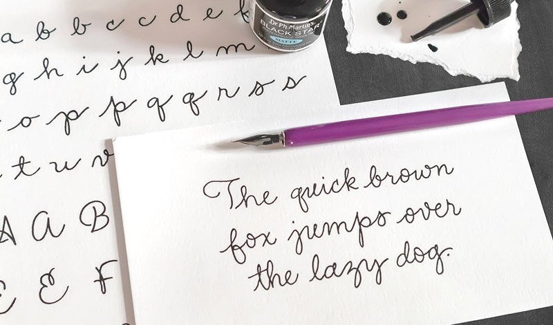 Modern style of monoline calligraphy in black ink on white paper with a purple calligraphy pen